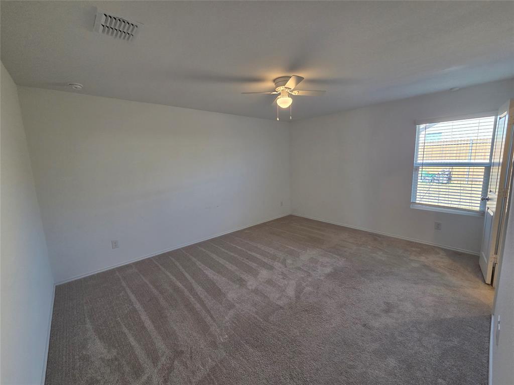 1001 Mountain Laurel Road Princeton, TX 75407 - Photo 8 of 19 Carpeted flooring, white painted walls, ceiling fan with integrated lighting, window with horizontal blinds, and a white interior door