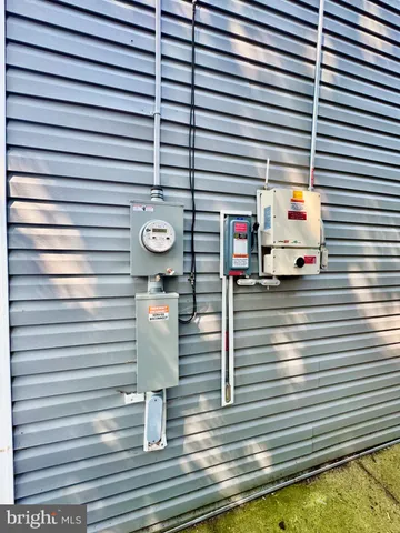 a view of a house with a wooden deck and a yard