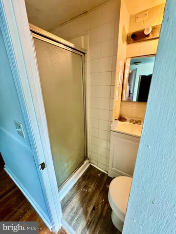 a bedroom with a bed and painting on the wall