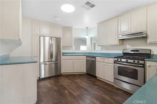 a kitchen with a white cabinets and white appliances