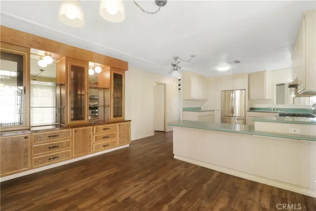 a large kitchen with kitchen island a large counter space a sink and appliances