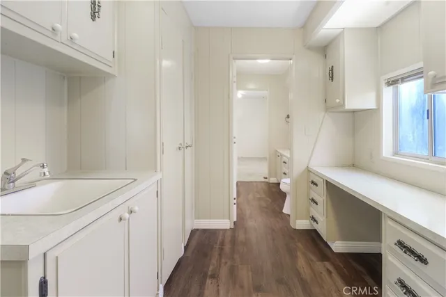 a spacious bathroom with a sink a mirror and a toilet