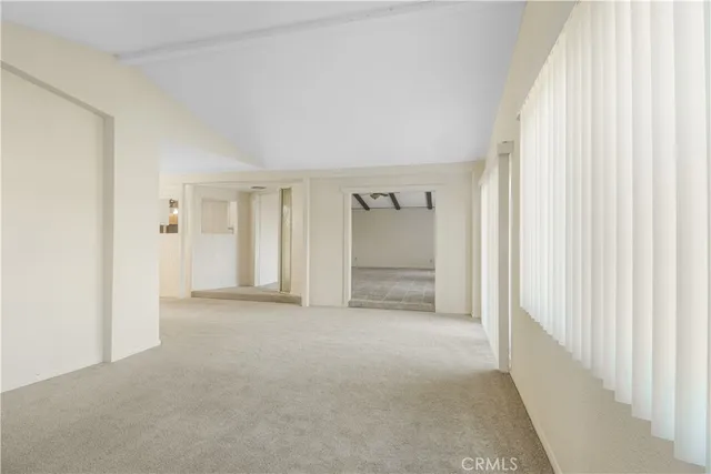 a view of an empty room and a window