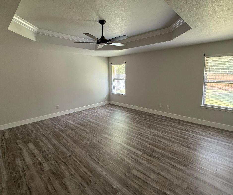505 Vale Loop Crestview, FL 32536 - Photo 11 of 14 a view of an empty room with wooden floor and a window