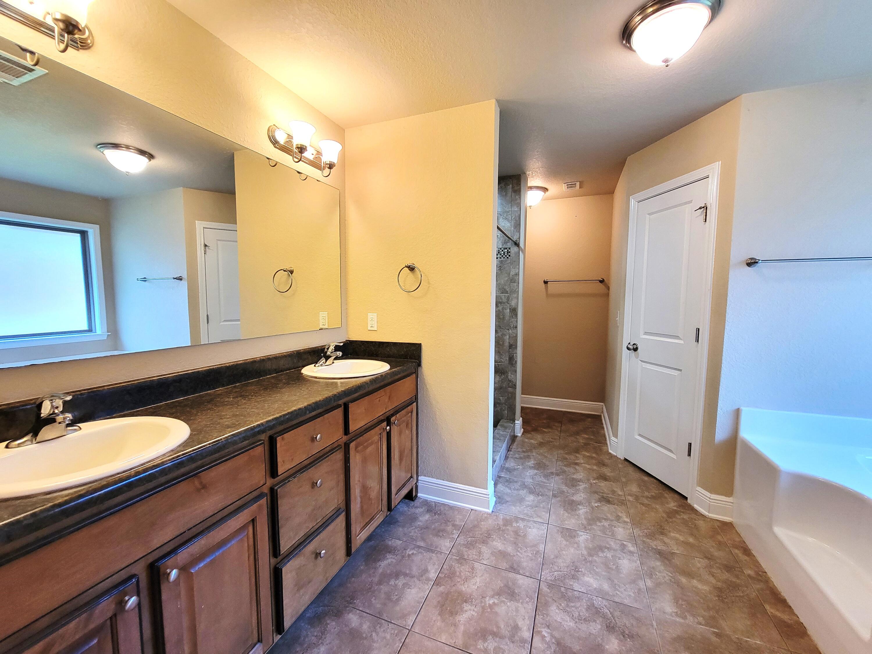 505 Vale Loop Crestview, FL 32536 - Photo 12 of 14 a bathroom with a double vanity sink and a mirror