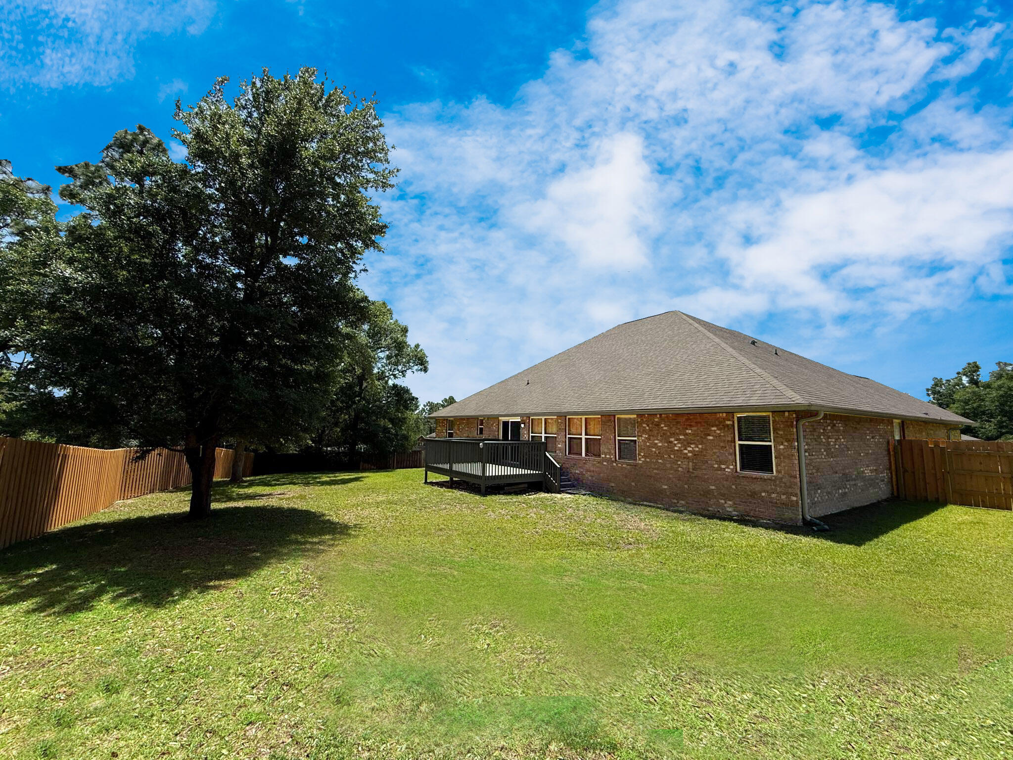 505 Vale Loop Crestview, FL 32536 - Photo 2 of 14 a big house with a big yard and large trees
