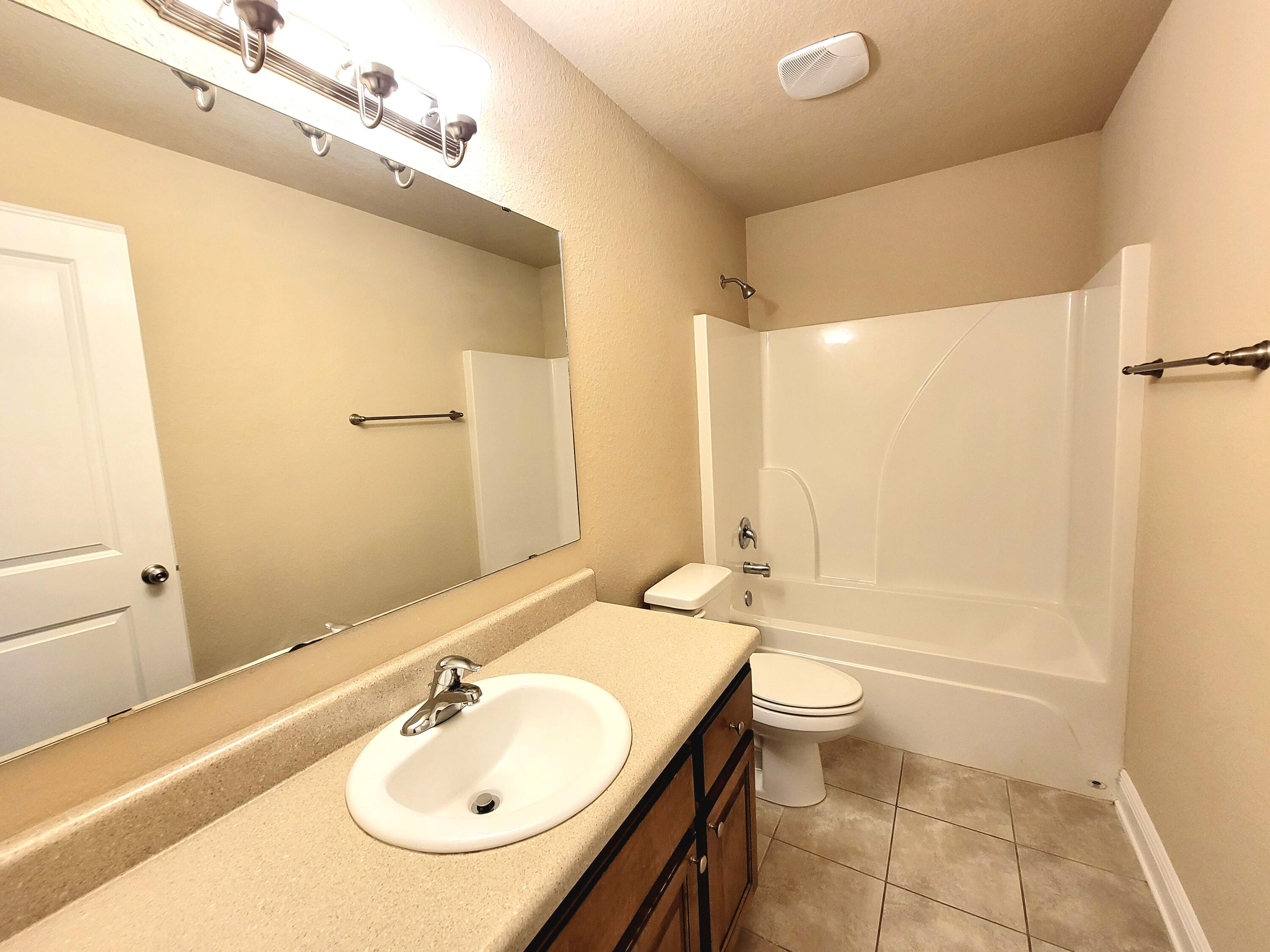 505 Vale Loop Crestview, FL 32536 - Photo 9 of 14 a bathroom with a sink a toilet and shower