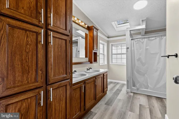 a bathroom with a double vanity sink and mirror