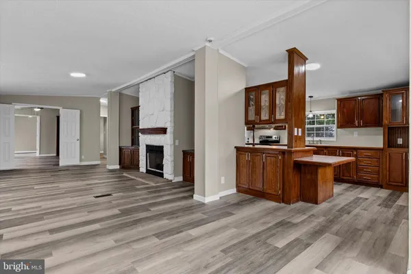 a large kitchen with stainless steel appliances granite countertop a stove and a sink
