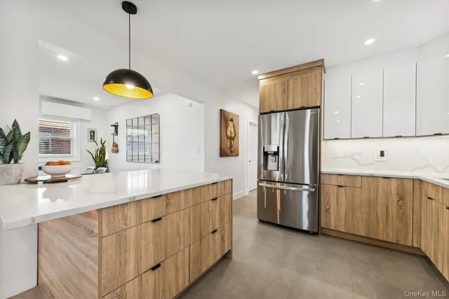 a kitchen with stainless steel appliances granite countertop a refrigerator a sink dishwasher a stove and a sink with wooden floor