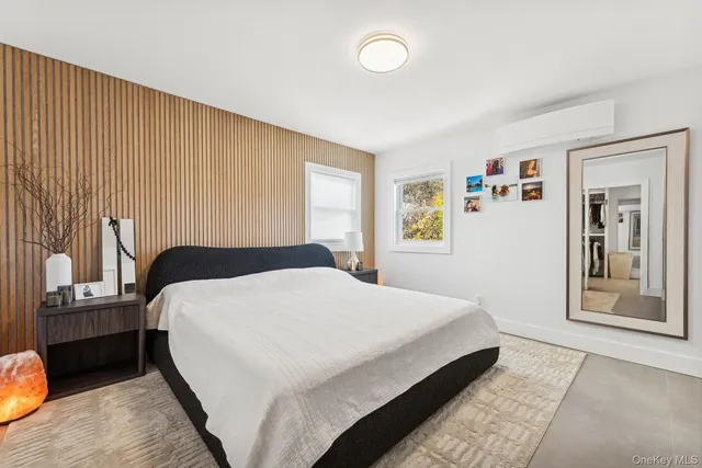 a bedroom with a bed and a painting on the wall