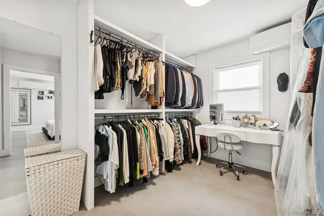 a view of walk in closet with clothes and shoes