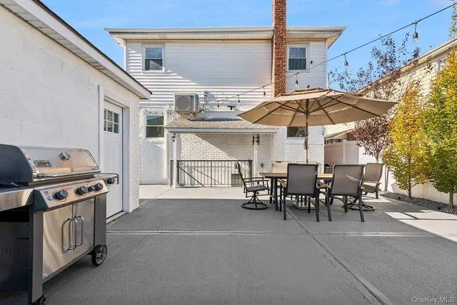 a view of a patio with a table and chairs under an umbrella