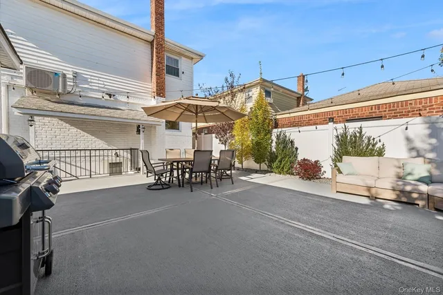 a view of a patio with table and chairs and potted plants