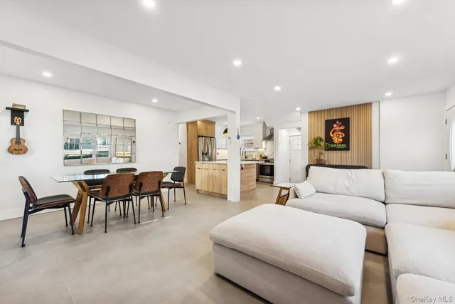 a living room with furniture and kitchen view