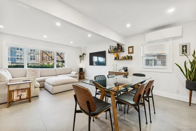 a view of a livingroom with furniture and a large window