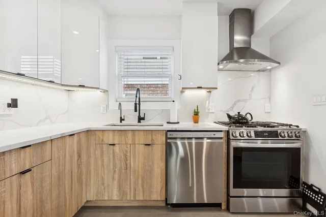 a kitchen with stainless steel appliances a stove a sink and a cabinets