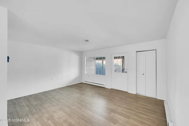 a view of a room with wooden floor