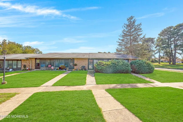 a view of yard with swimming pool and green space