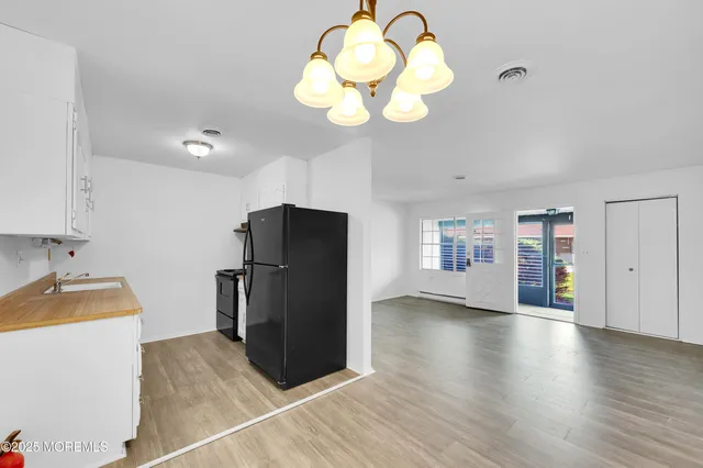 a kitchen with granite countertop a refrigerator and a sink