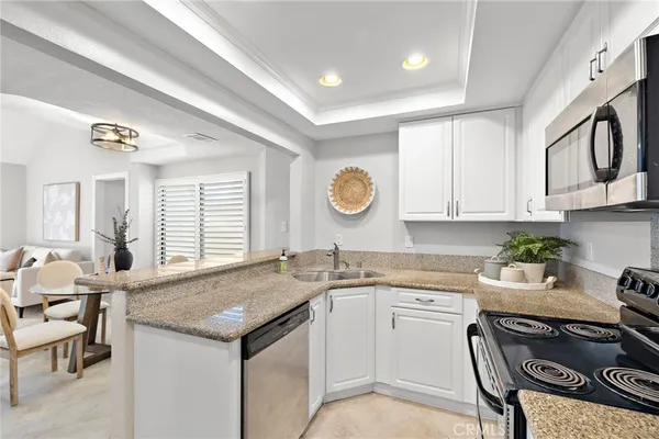 a kitchen with a stove a sink and a refrigerator