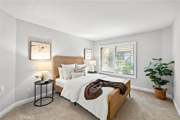 a bed room with a bed and a potted plant
