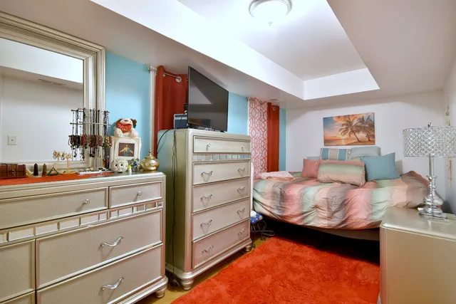 a bedroom with a bed and a dresser