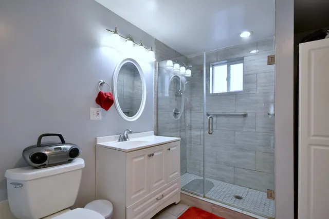 a bathroom with a sink toilet and shower