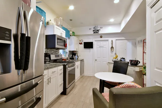 a kitchen with stainless steel appliances a stove refrigerator sink and stove
