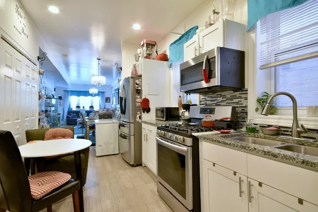 a kitchen with a sink stove and white cabinets