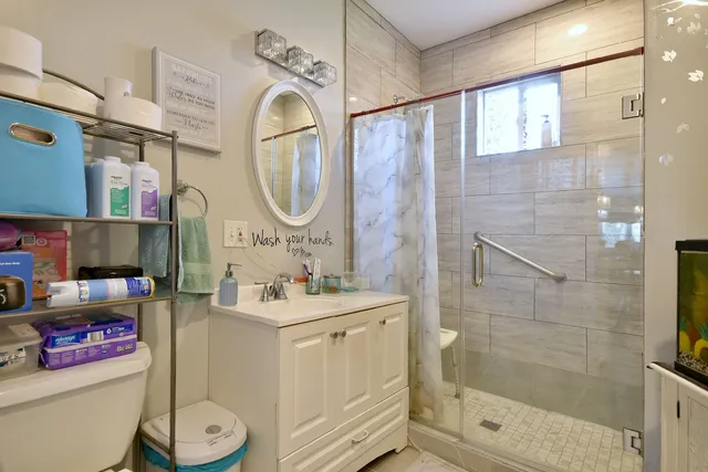 a bathroom with a sink mirror vanity and toilet