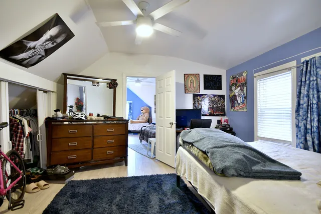 a living room with furniture a flat screen tv and a dresser