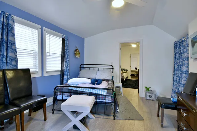 a bedroom with a bed and wooden floor