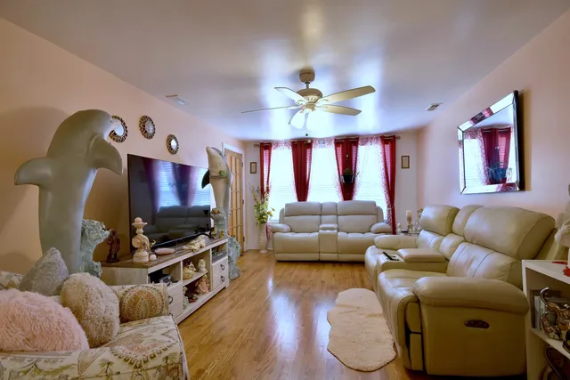 a living room with furniture a ceiling fan and a rug