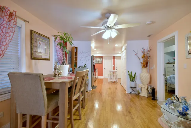 a view of a dining room with furniture and wooden floor