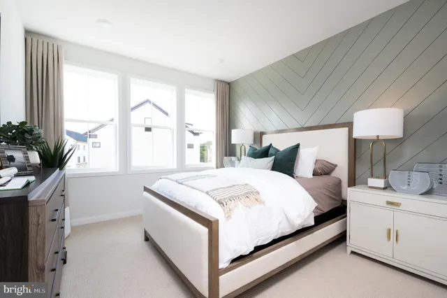 a bed room with a bed and a potted plant