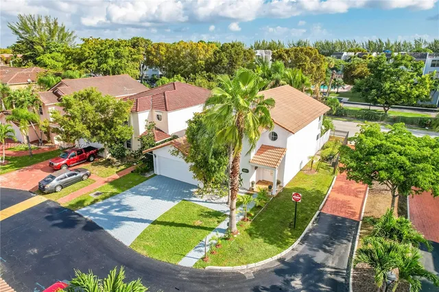 an aerial view of residential houses with outdoor space