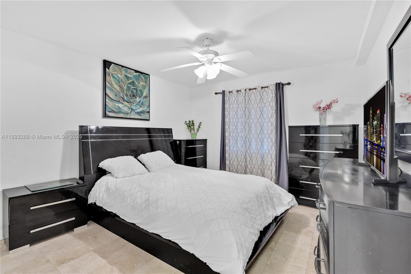 8909 Southwest 108th Circle Miami, FL 33176 - Photo 14 of 28 a bedroom with a bed and a chandelier