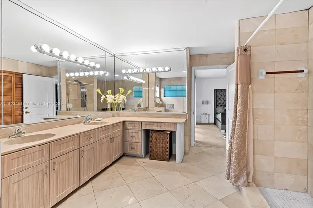 a bathroom with a sink a mirror and a shower