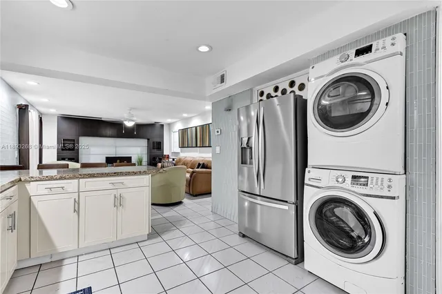 an aerial view of a house with a yard and lake view