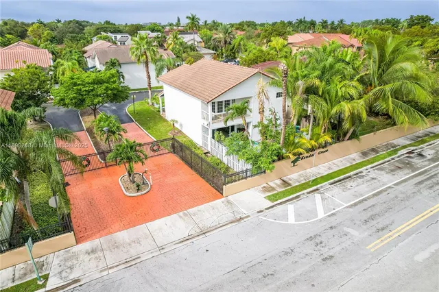 an aerial view of residential houses with outdoor space and river