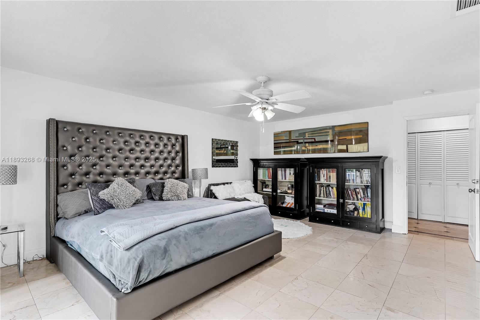 8909 Southwest 108th Circle Miami, FL 33176 - Photo 10 of 28 a bedroom with a large bed and a chandelier