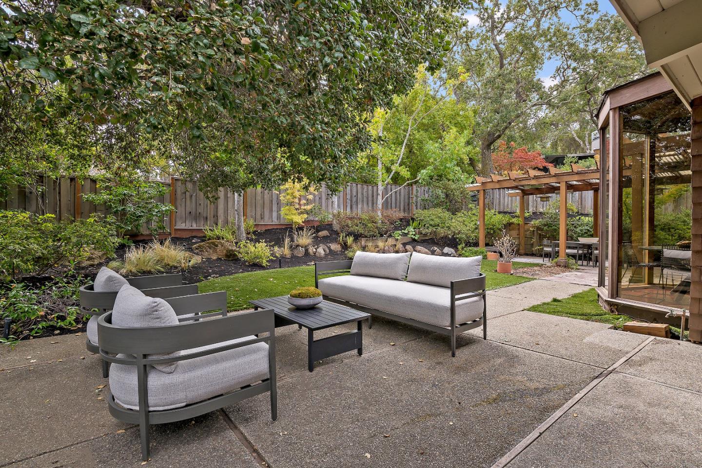 60 Linaria Way Portola Valley, CA 94028 - Photo 34 of 39 a view of a patio with couches and a fire pit and wooden fence
