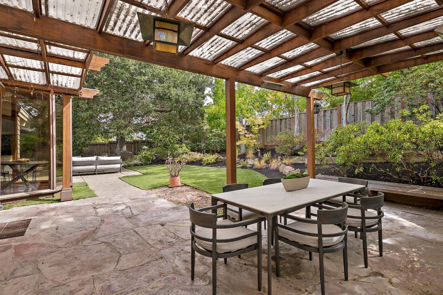 60 Linaria Way Portola Valley, CA 94028 - Photo 36 of 39 a view of a patio with a table chairs and a backyard