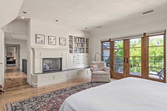 a spacious bedroom with a large bed and a fireplace