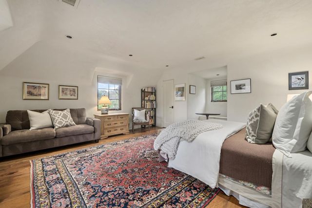 a bedroom with a bed and couch