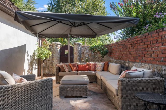 a outdoor living space with furniture and a black umbrella