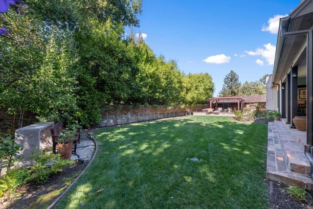 a view of a garden with a building in the background