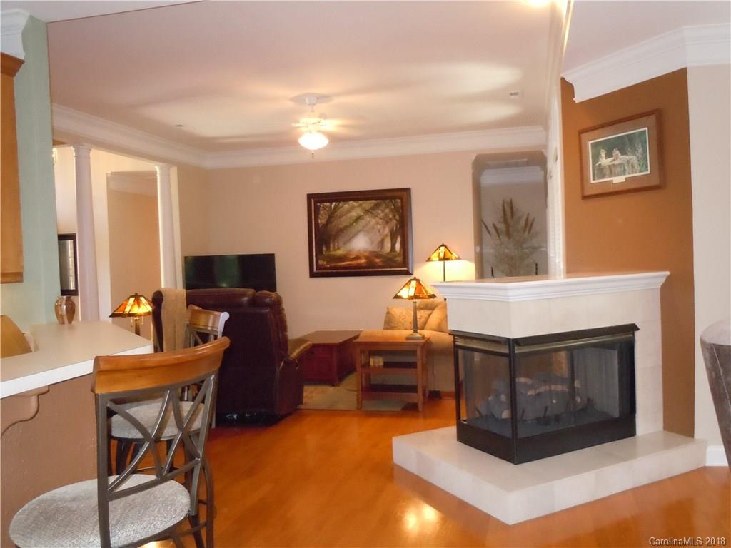 124 Zimmerman Drive Fort Mill, SC 29708 - Photo 13 of 35 a living room with furniture a flat screen tv and a fireplace