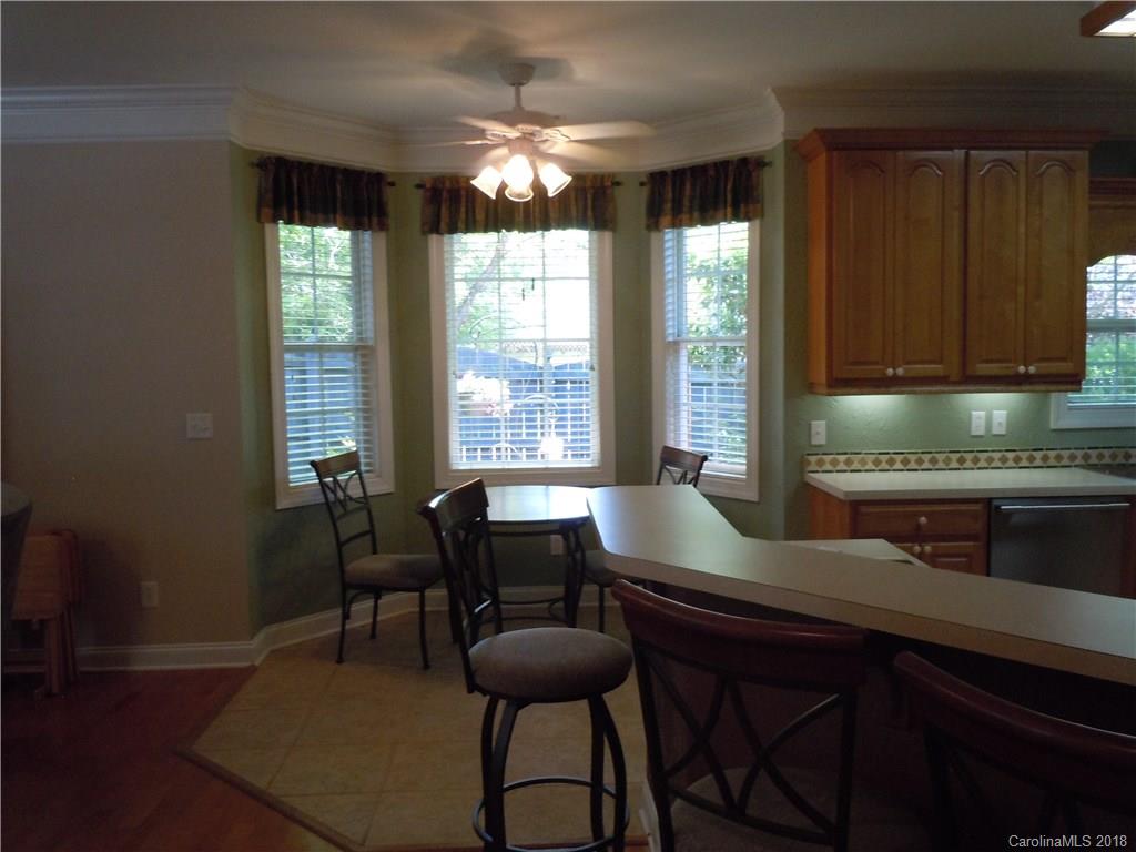 124 Zimmerman Drive Fort Mill, SC 29708 - Photo 15 of 35 a kitchen with a table chairs and cabinets